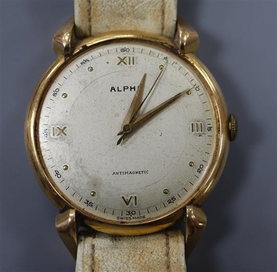 A gentlemans Swiss 750 yellow metal Alpha manual wind wrist watch, on associated strap.